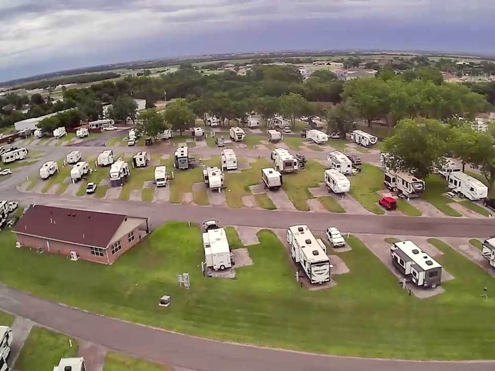 Aerial view of Pecan Grove RV Resort showing rows of RV sites, lawns and pecan trees