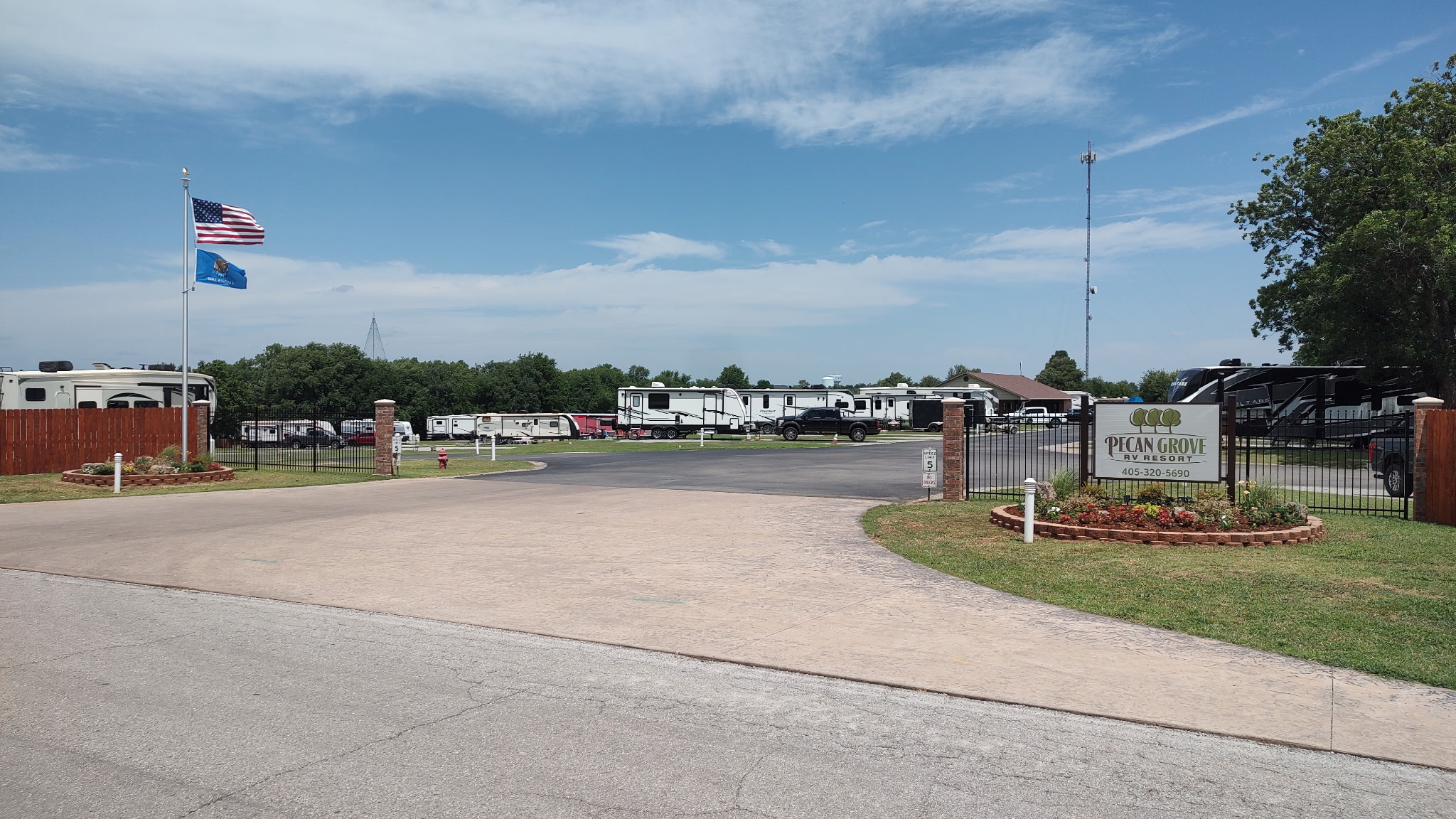 The gated entrance drive into Pecan Grove RV Resort