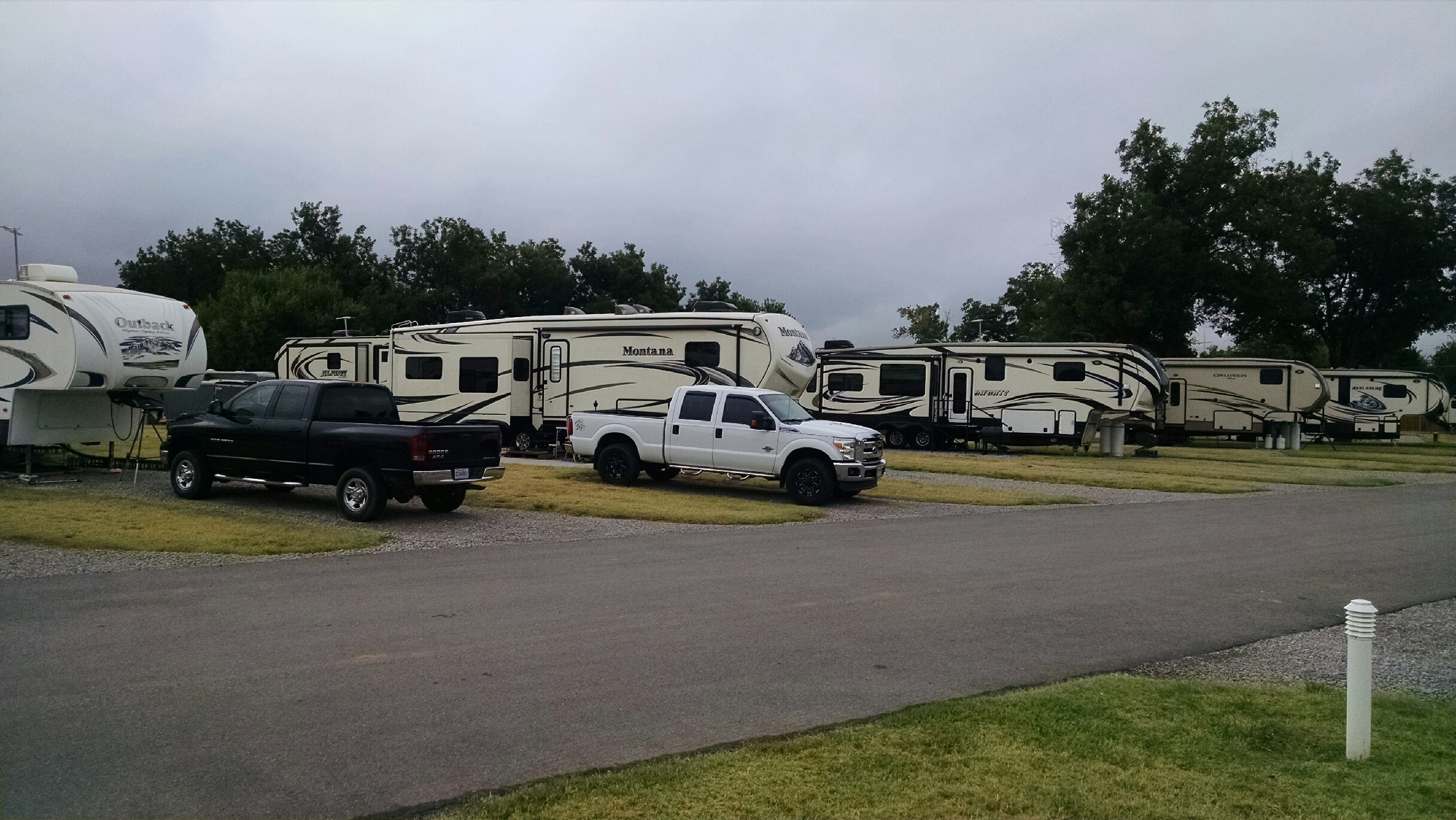 RVs parked on paved sites with mown grass between them